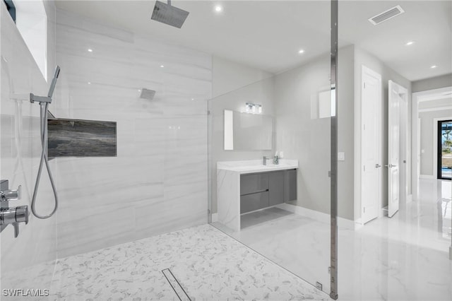 bathroom featuring vanity and tiled shower