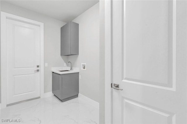 laundry area with cabinets, sink, and hookup for a washing machine