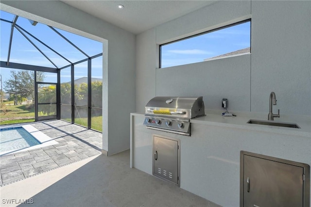 view of patio / terrace with area for grilling, sink, grilling area, and glass enclosure