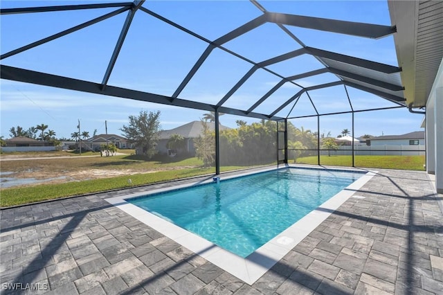 view of pool featuring a lanai, a patio area, and a lawn