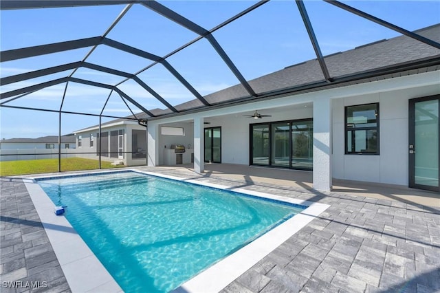 view of swimming pool featuring grilling area, a patio, ceiling fan, and glass enclosure