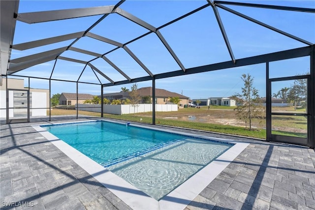 view of swimming pool featuring a patio and glass enclosure