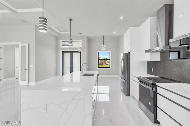 kitchen with white cabinetry, hanging light fixtures, stainless steel appliances, light stone countertops, and wall chimney range hood