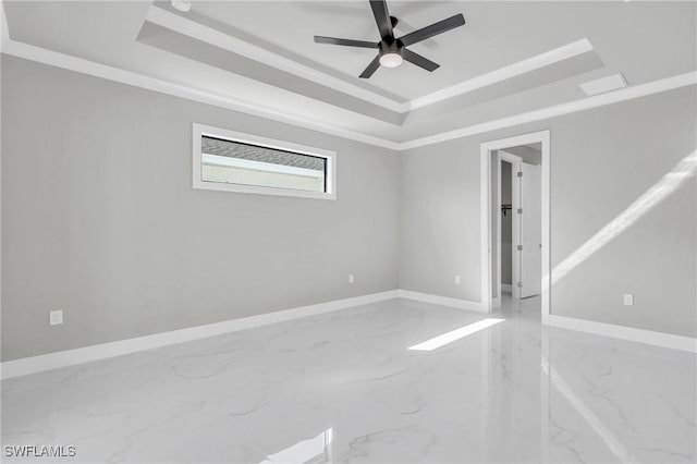 unfurnished room with ceiling fan, ornamental molding, and a tray ceiling