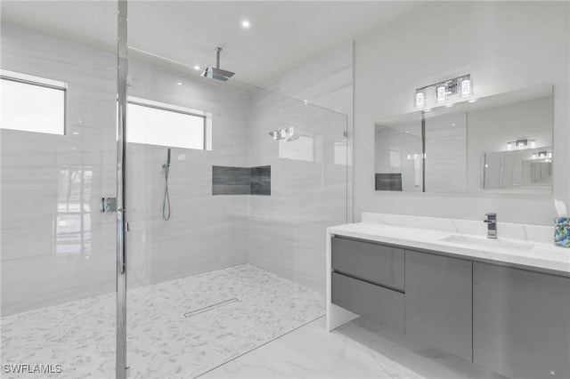 bathroom with vanity and a tile shower