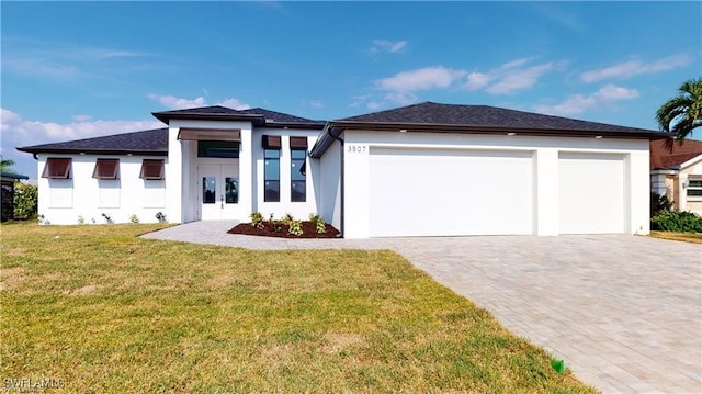 prairie-style house with a garage and a front lawn