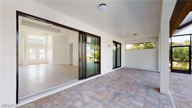 view of patio with glass enclosure