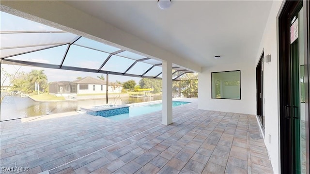 view of pool featuring a hot tub, a patio area, and a lanai