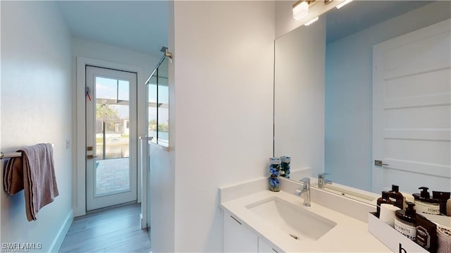 bathroom with hardwood / wood-style flooring and vanity