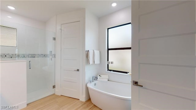 bathroom with wood-type flooring and plus walk in shower