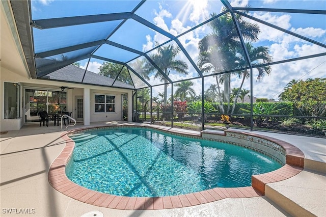 view of swimming pool with pool water feature, a lanai, and a patio