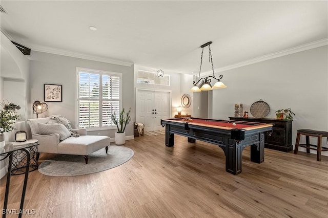 game room with pool table, visible vents, baseboards, ornamental molding, and light wood finished floors