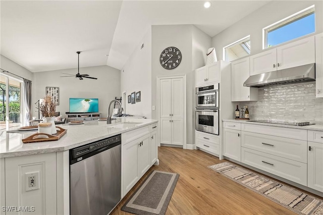 kitchen featuring an island with sink, white cabinets, and appliances with stainless steel finishes