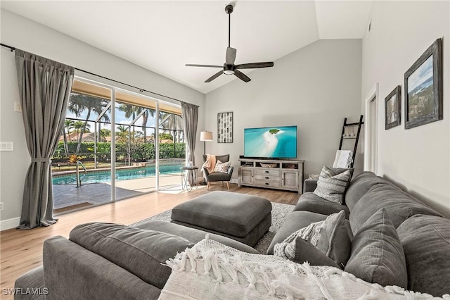 living room with wood-type flooring, vaulted ceiling, and ceiling fan