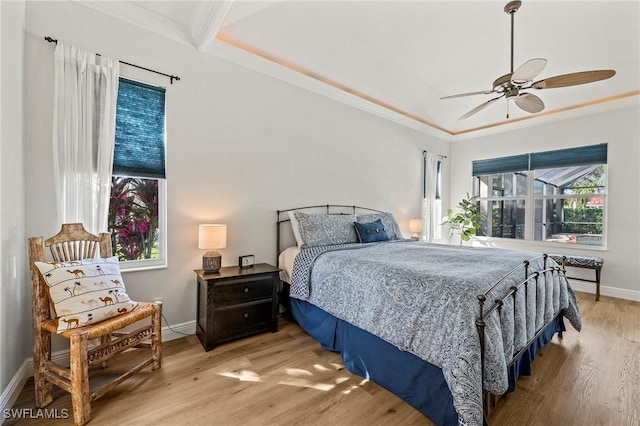 bedroom featuring crown molding, ceiling fan, and light wood-type flooring