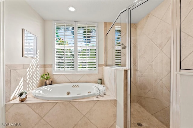 bathroom featuring independent shower and bath