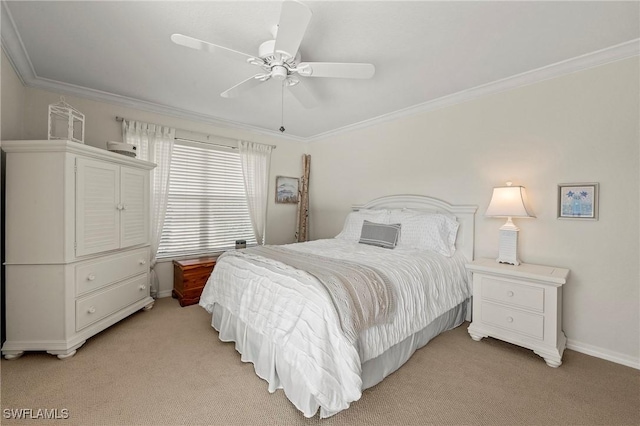 bedroom featuring ornamental molding, light colored carpet, and ceiling fan