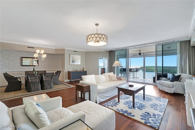 living room with a water view, ornamental molding, floor to ceiling windows, and wood-type flooring