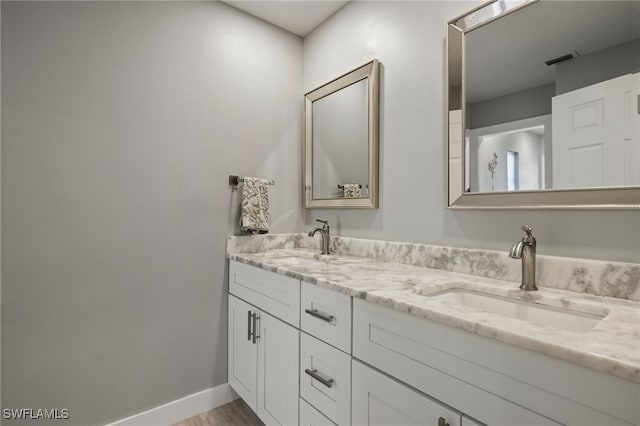 bathroom with vanity and hardwood / wood-style floors