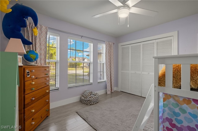 bedroom featuring a closet, ceiling fan, and light hardwood / wood-style flooring