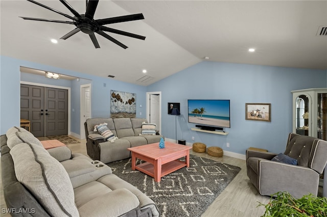 living room featuring lofted ceiling, light hardwood / wood-style floors, and ceiling fan