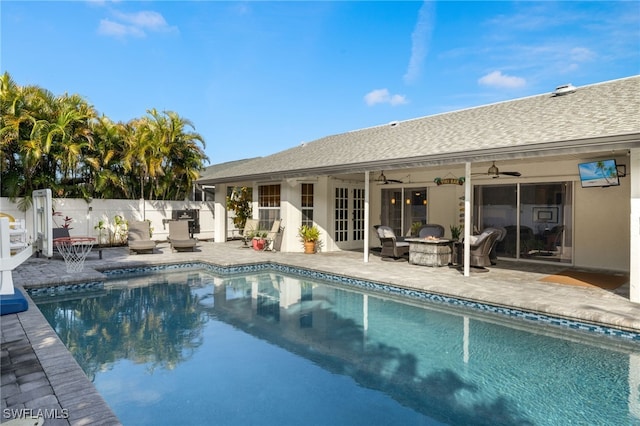 view of pool with a fenced in pool, a patio, an outdoor fire pit, ceiling fan, and fence