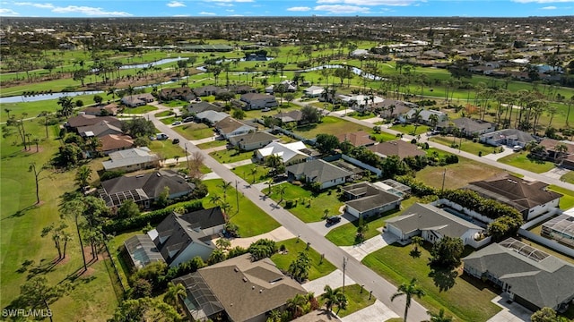 birds eye view of property with a water view and a residential view