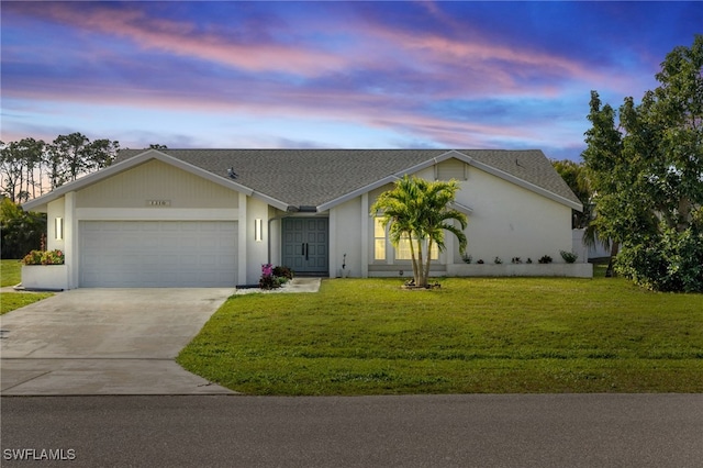 view of front of home with a shingled roof, concrete driveway, an attached garage, and a front lawn