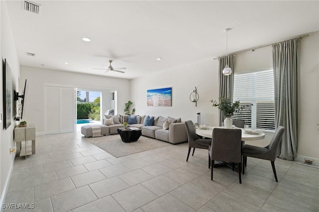 living room with light tile patterned flooring and ceiling fan