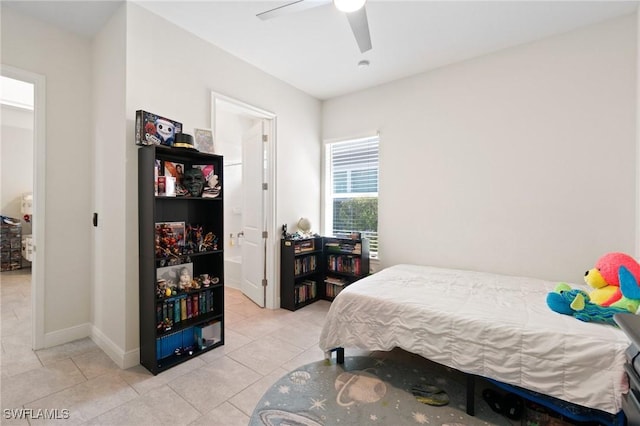 tiled bedroom featuring ceiling fan