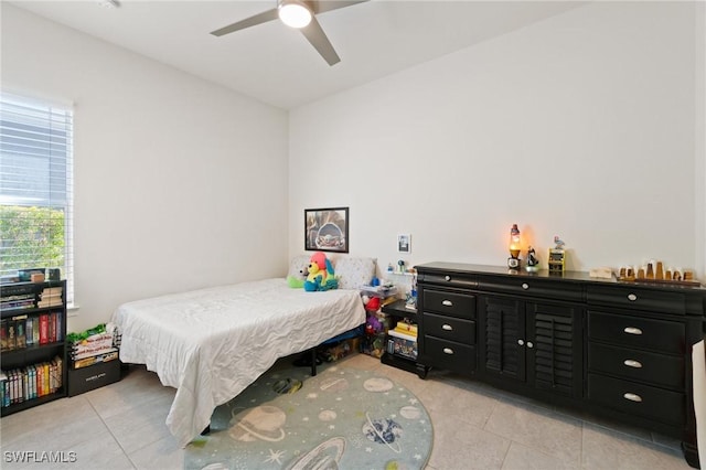 tiled bedroom with ceiling fan