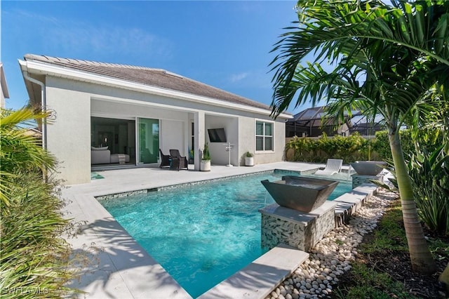 back of house featuring a lanai and a patio area