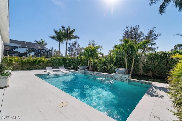 view of swimming pool featuring a patio area, pool water feature, and glass enclosure