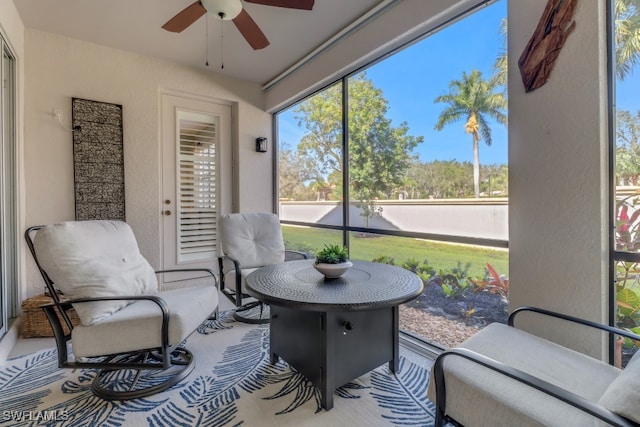 sunroom featuring ceiling fan