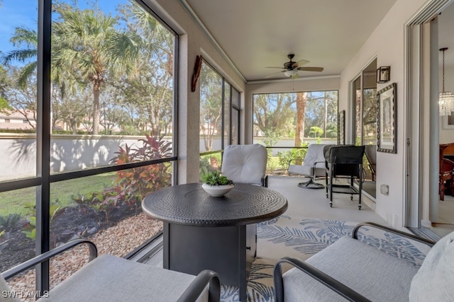 sunroom / solarium featuring ceiling fan