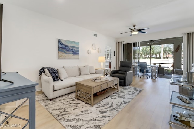 living room featuring ceiling fan and light wood-type flooring