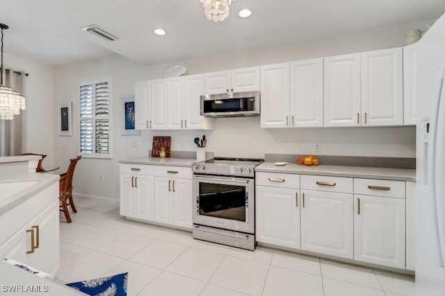 kitchen featuring stainless steel appliances, white cabinetry, a chandelier, and decorative light fixtures