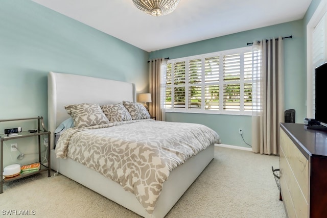 bedroom featuring light colored carpet