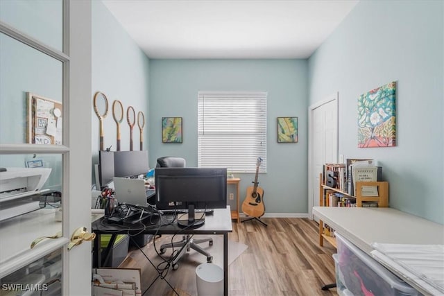 office with light hardwood / wood-style floors