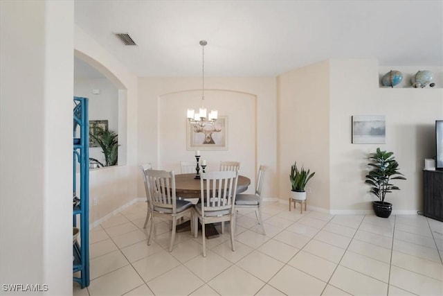 dining room with an inviting chandelier and light tile patterned flooring