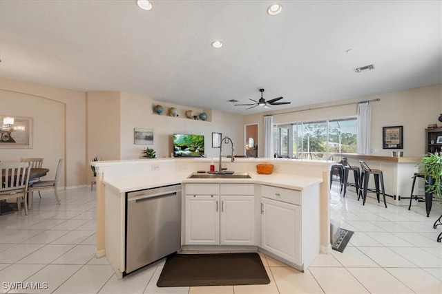 kitchen with sink, light tile patterned floors, white cabinetry, a center island with sink, and stainless steel dishwasher