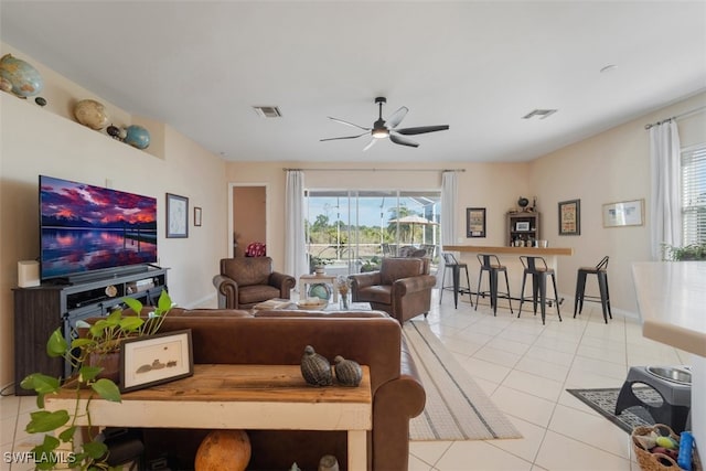 living room with light tile patterned floors, a wealth of natural light, and ceiling fan