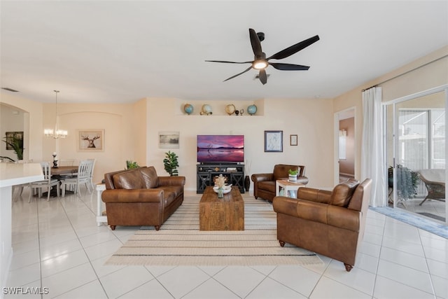 tiled living room featuring ceiling fan with notable chandelier