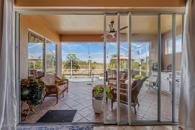 sunroom featuring ceiling fan