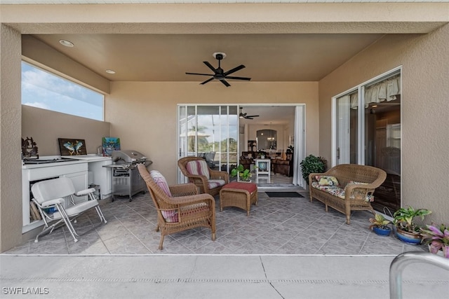 view of patio with area for grilling and ceiling fan