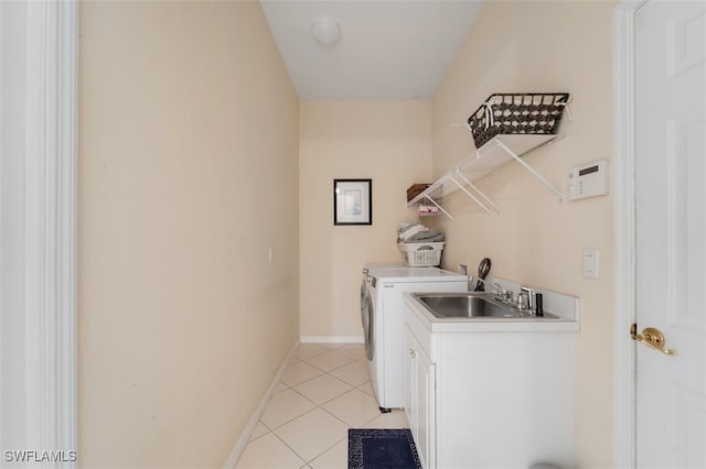 clothes washing area with cabinets, separate washer and dryer, sink, and light tile patterned floors