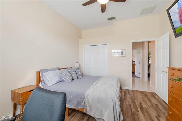 bedroom featuring hardwood / wood-style floors, a closet, and ceiling fan