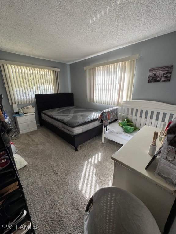 carpeted bedroom with a textured ceiling