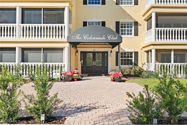 doorway to property featuring stucco siding and french doors