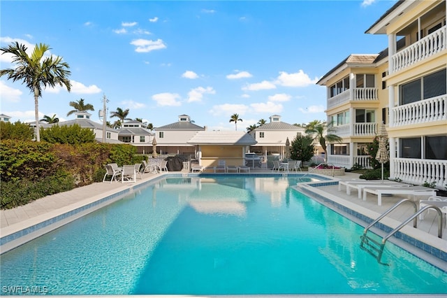 pool featuring fence and a patio